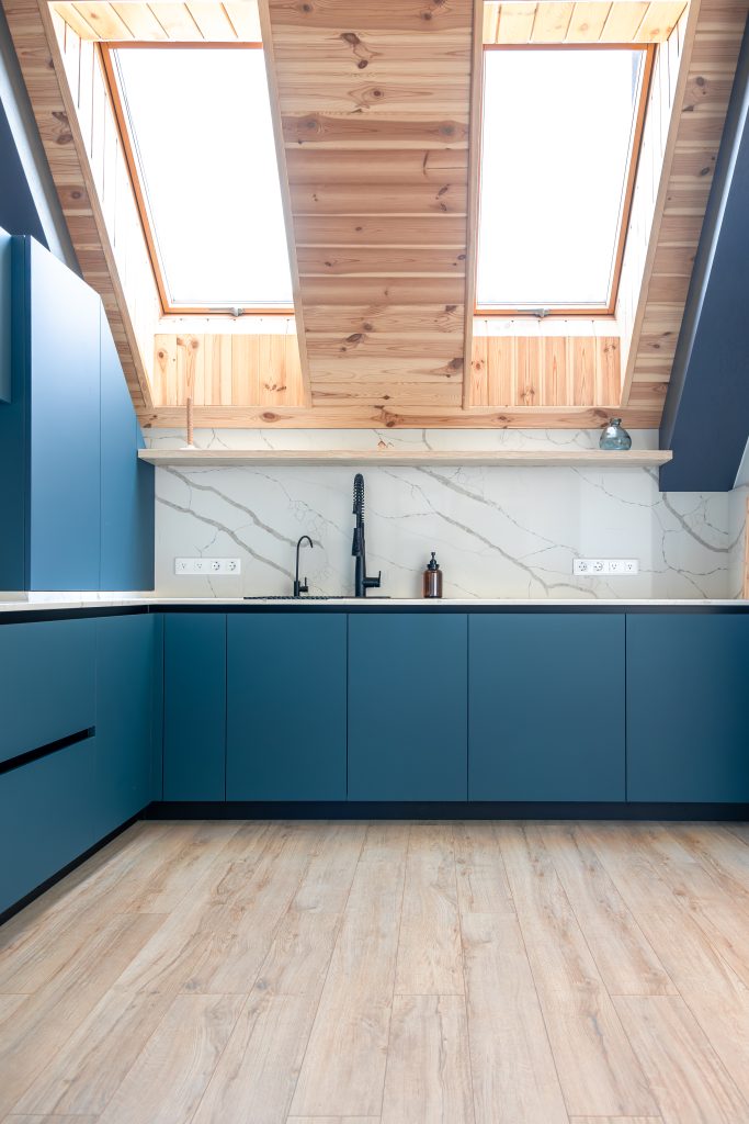 bright attic kitchen. natural wood ceiling. large skylights.